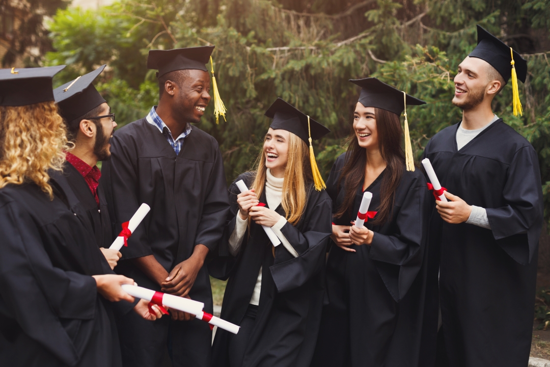 group of multiethnic students enjoying graduation